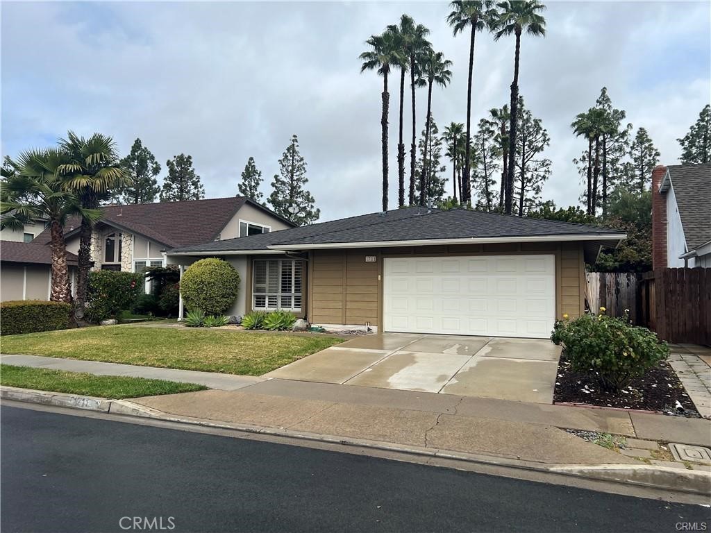 1711 Heather Avenue Tustin, CA 92780 - Photo 11 of 13 a front view of a house with a garden and trees