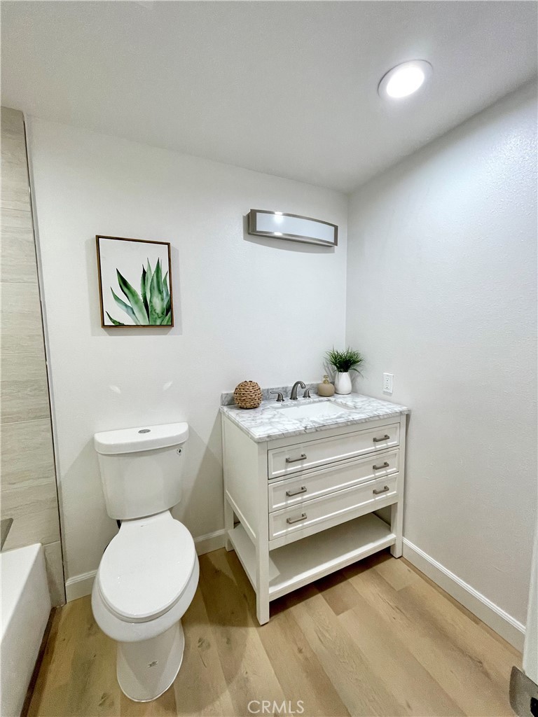 1711 Heather Avenue Tustin, CA 92780 - Photo 5 of 13 a bathroom with a toilet a sink and a mirror