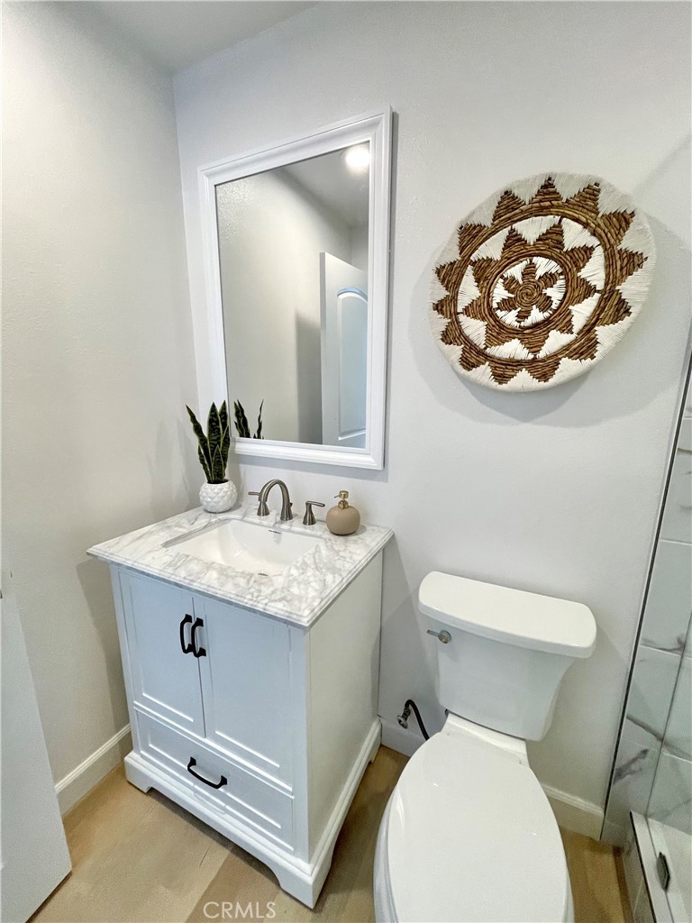1711 Heather Avenue Tustin, CA 92780 - Photo 10 of 13 a bathroom with a granite countertop toilet sink and mirror