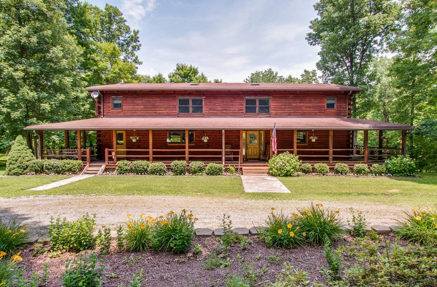 a front view of a house with a yard table and chairs