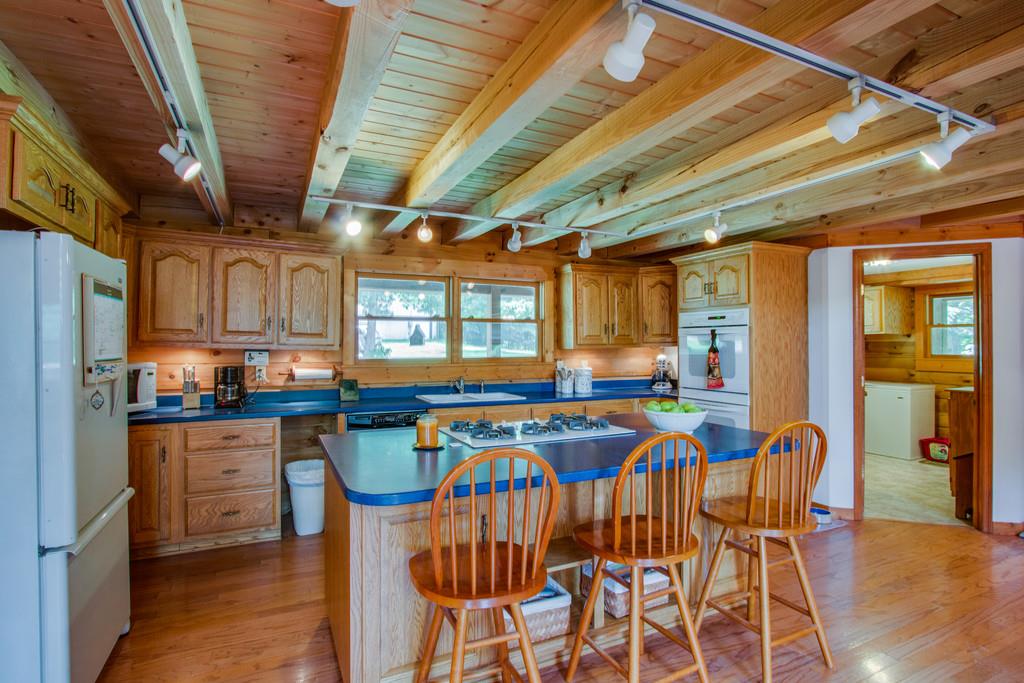 744 Keytown Road Portland, TN 37148 - Photo 8 of 30 a kitchen with stainless steel appliances granite countertop a table chairs and wooden floor