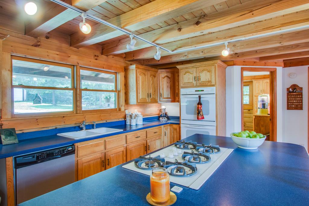744 Keytown Road Portland, TN 37148 - Photo 10 of 30 a kitchen with stainless steel appliances granite countertop a sink stove and wooden cabinets