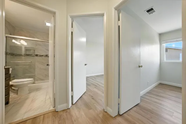a view of a bathroom with a glass door shower