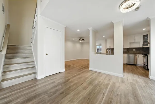 a view of a kitchen with wooden floor and a kitchen
