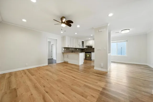 a view of a kitchen with a sink stainless steel appliances and cabinets