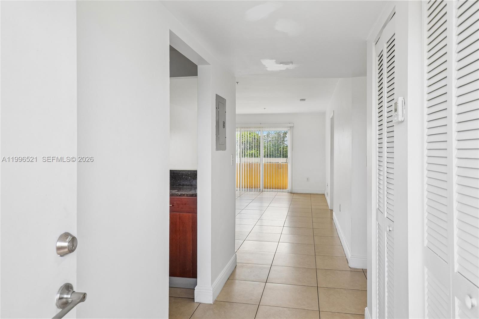 4137 Stirling Road, Unit 507 Dania Beach, FL 33314 - Photo 4 of 20 a view of a hallway to rooms and wooden floor