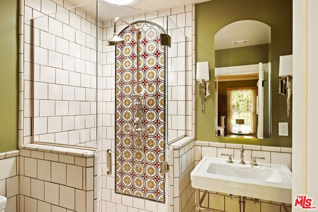 a bathroom with a sink a vanity and a mirror