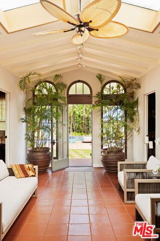a living room with furniture and a floor to ceiling window
