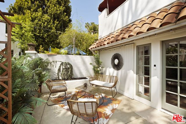 a view of a chairs and table in backyard of the house