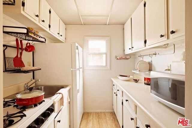 a utility room with sink dryer and washer