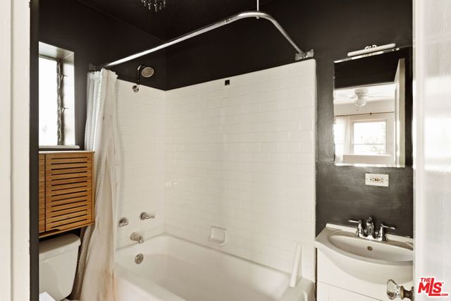 a bathroom with a bathtub and shower