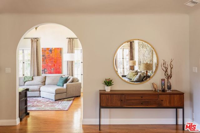 a living room with furniture and a large mirror