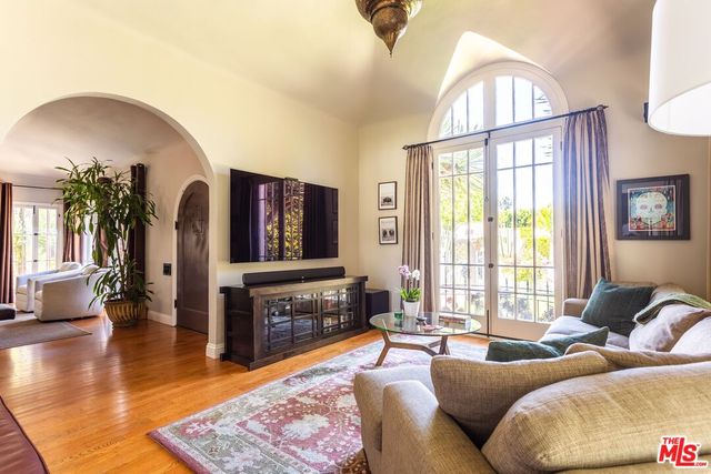 a living room with furniture fireplace and a large window