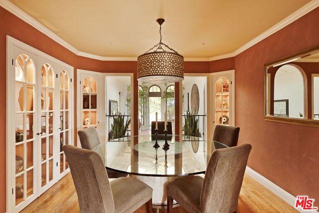 a dining room with furniture a chandelier and wooden floor