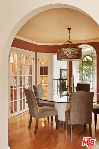 a view of a dining room with furniture wooden floor and chandelier