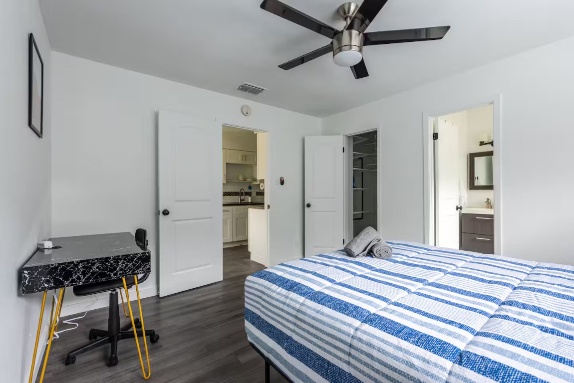 9715 Dallum Drive Austin, TX 78753 - Photo 16 of 21 a bedroom with a bed and a table in it