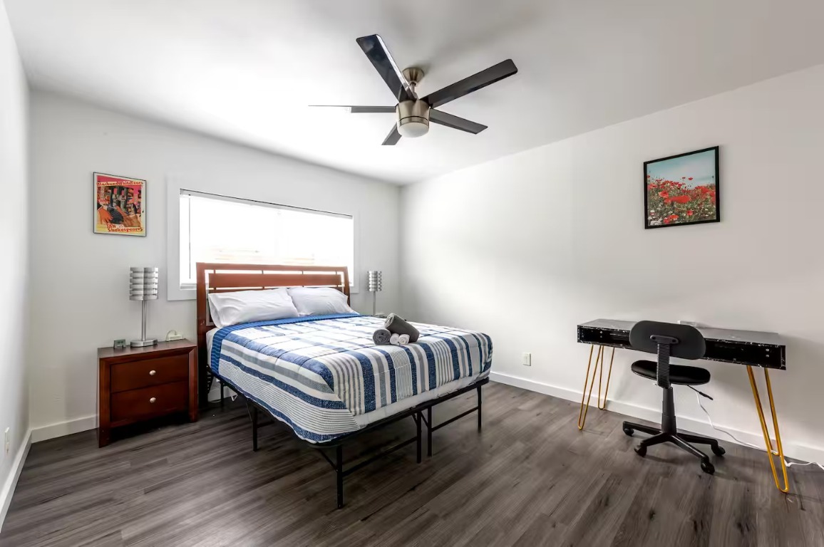 9715 Dallum Drive Austin, TX 78753 - Photo 8 of 21 a bedroom with a bed and wooden floor