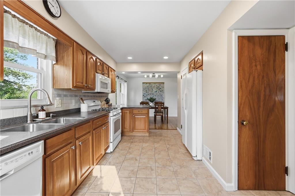 835 Wible Run Road Pittsburgh, PA 15209 - Photo 18 of 50 a large kitchen with stainless steel appliances granite countertop a refrigerator and a sink