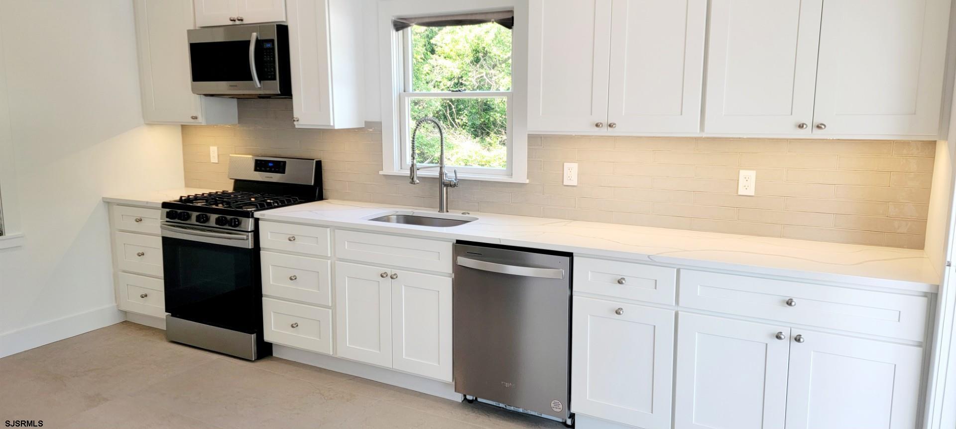 6594 Mill Road Egg Harbor Township, NJ 08234 - Photo 12 of 72 a kitchen with a sink cabinets and a window