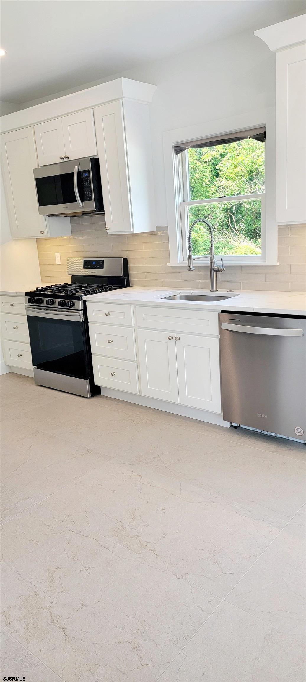 6594 Mill Road Egg Harbor Township, NJ 08234 - Photo 18 of 72 a kitchen with granite countertop a stove and a sink