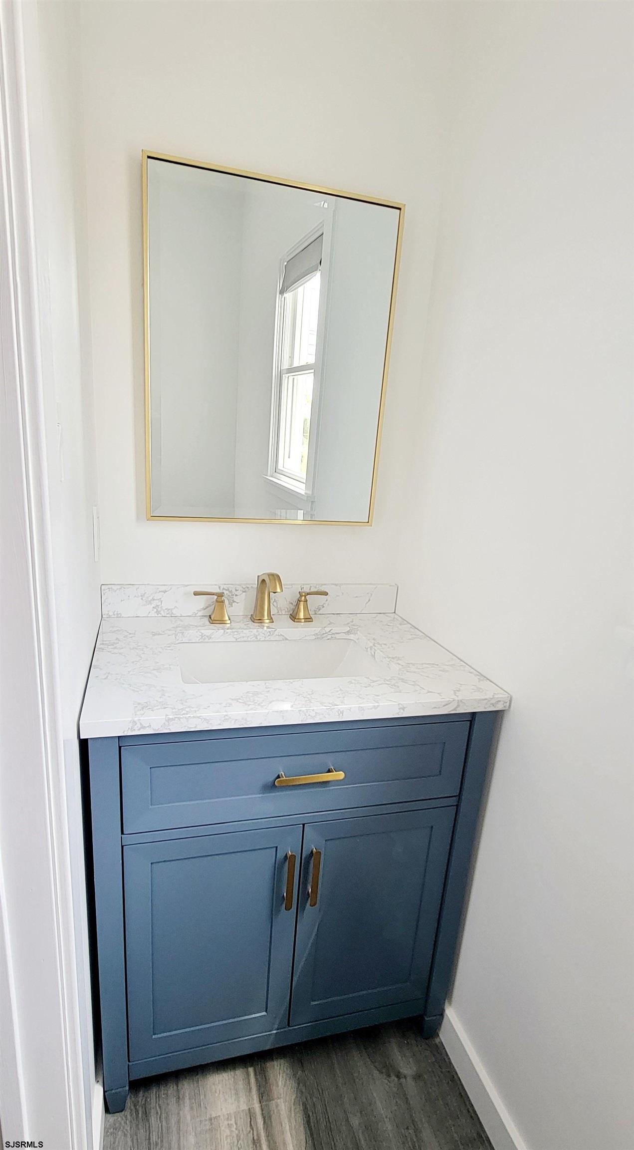 6594 Mill Road Egg Harbor Township, NJ 08234 - Photo 20 of 72 a bathroom with a sink vanity and mirror
