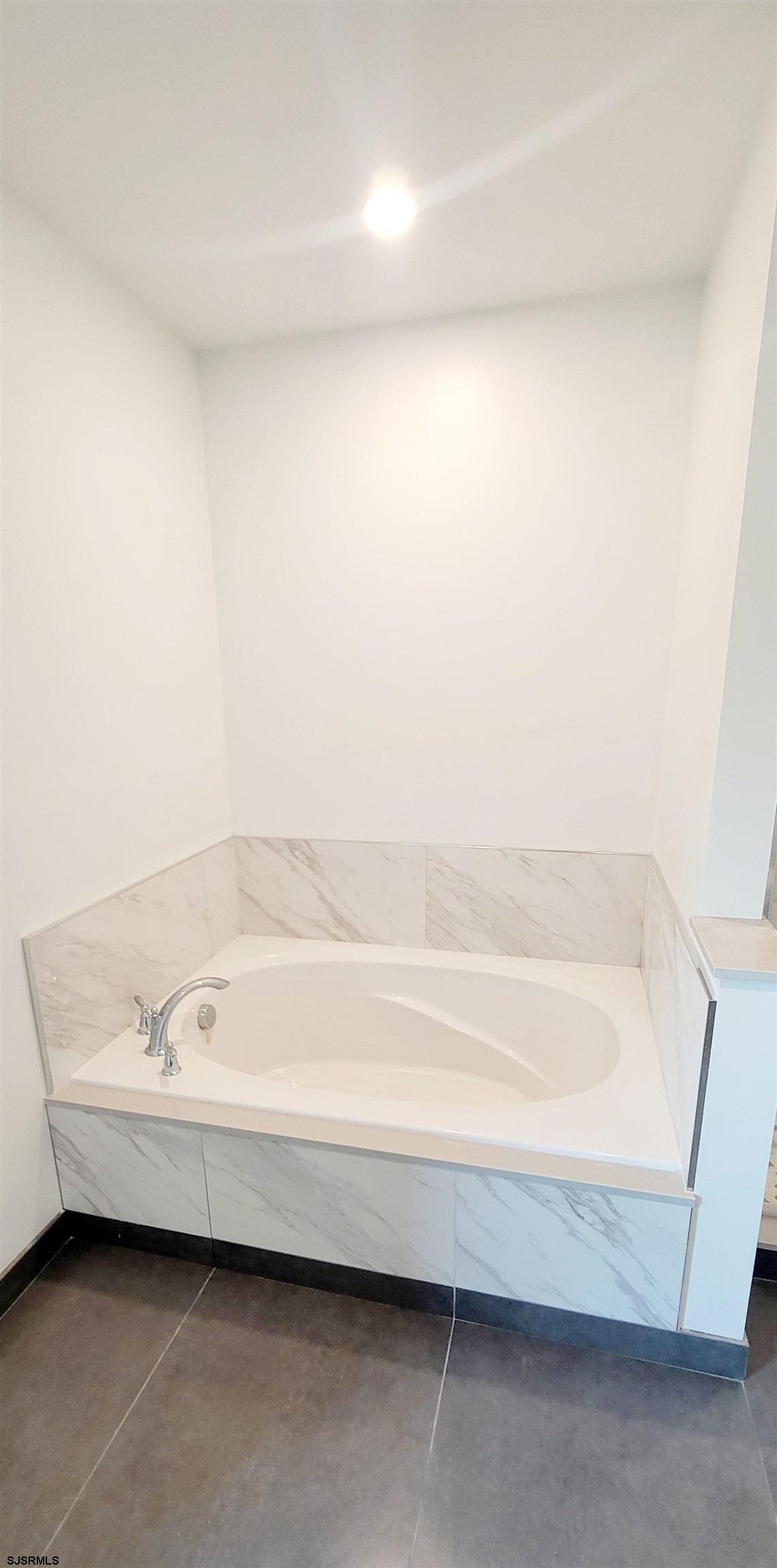 6594 Mill Road Egg Harbor Township, NJ 08234 - Photo 21 of 72 a bathroom with a bathtub and a shower