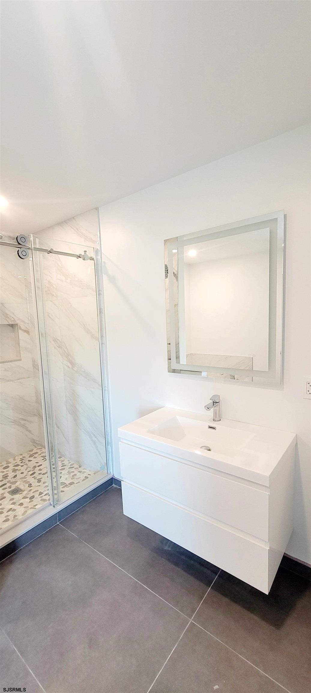 6594 Mill Road Egg Harbor Township, NJ 08234 - Photo 22 of 72 a bathroom with a bathtub and a shower