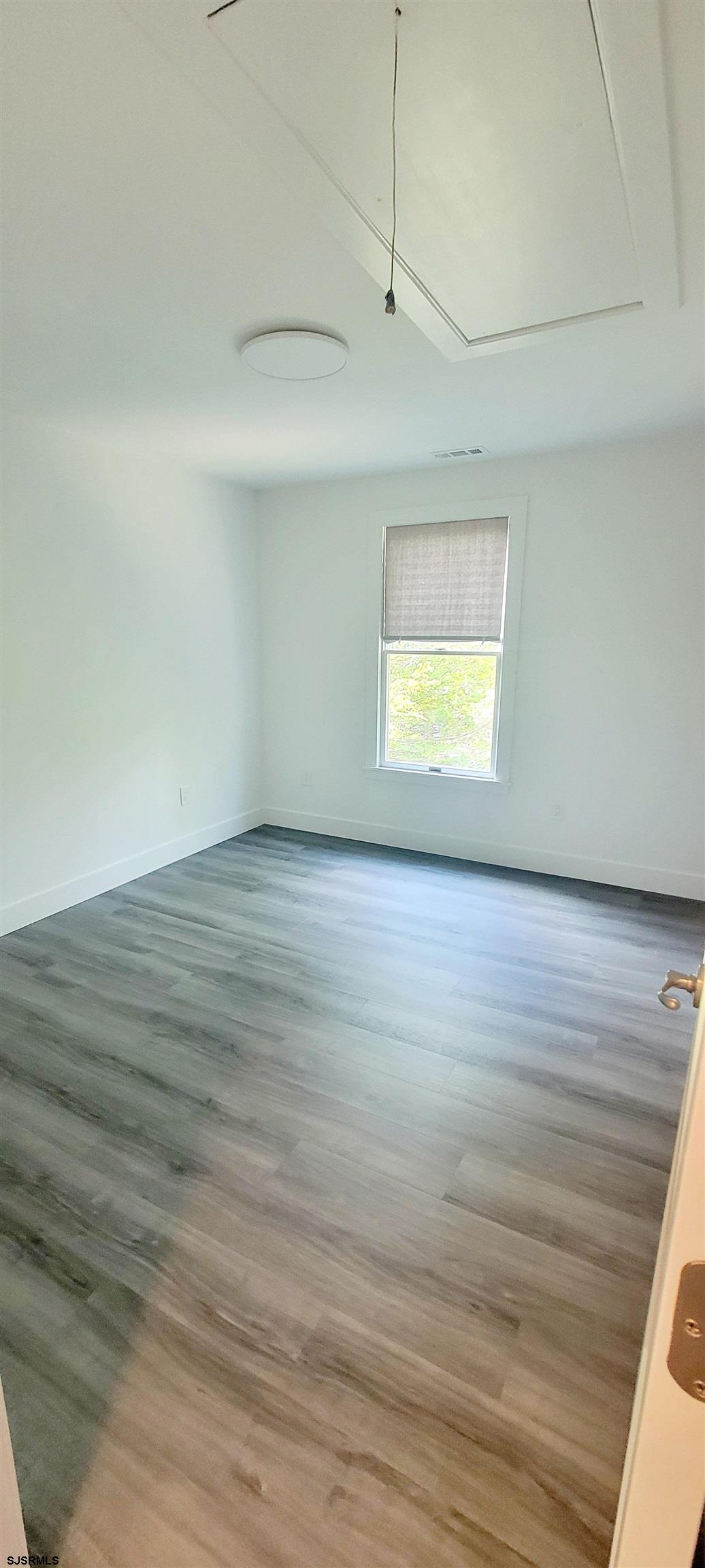 6594 Mill Road Egg Harbor Township, NJ 08234 - Photo 40 of 72 an empty room with wooden floor and windows