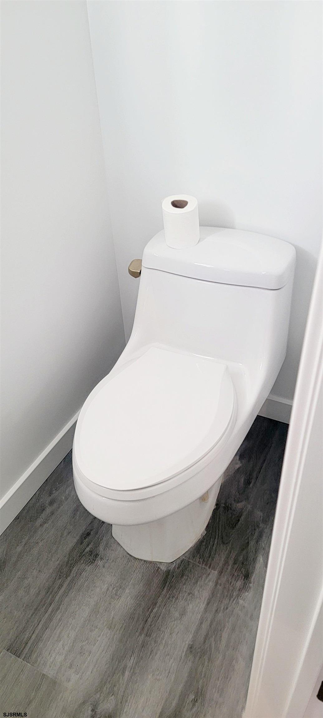 6594 Mill Road Egg Harbor Township, NJ 08234 - Photo 61 of 72 a bathroom with a toilet and a sink