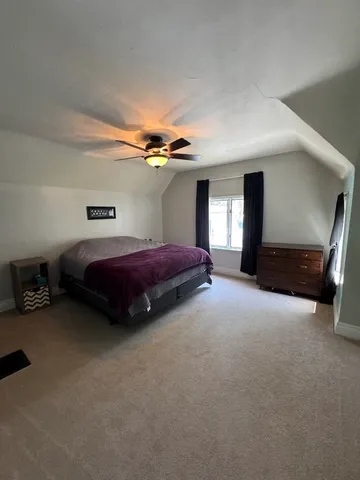 a bedroom with bed and window