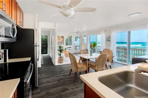 a dining room with furniture a chandelier and wooden floor