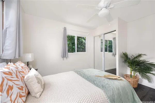 a bedroom with a large bed and a window