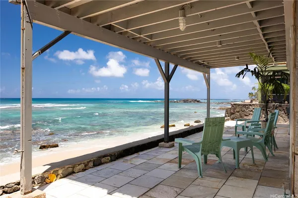 a view of a chairs and table in the patio