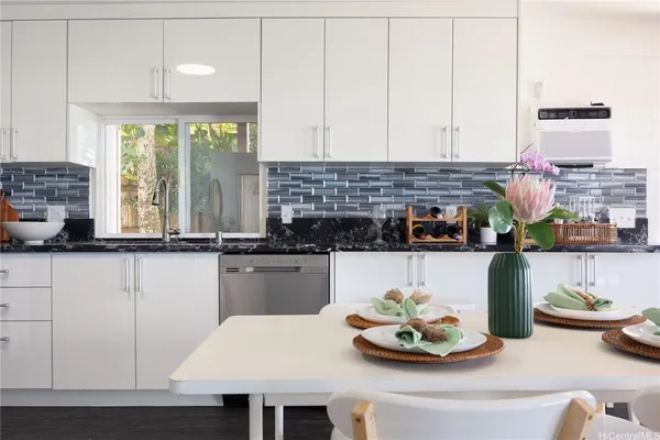 a kitchen with a table and chairs