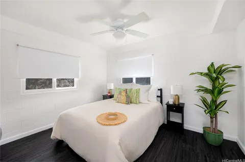 a bedroom with a bed and a potted plant