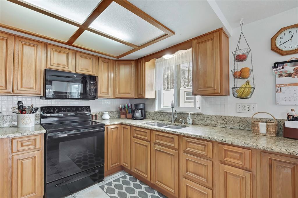6601 Sea Ranch Drive Hudson, FL 34667 - Photo 11 of 43 a kitchen with granite countertop stainless steel appliances a stove sink and microwave