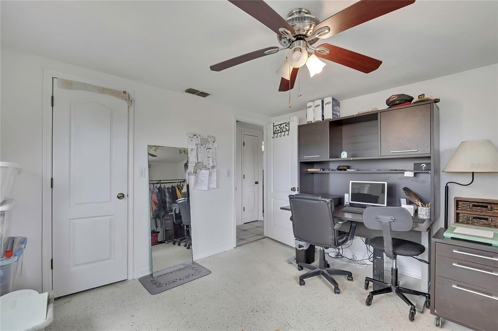 6601 Sea Ranch Drive Hudson, FL 34667 - Photo 16 of 43 a view of a workspace with furniture and a ceiling fan