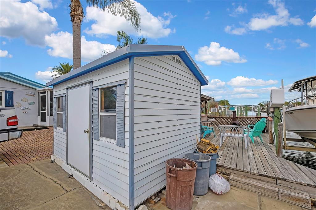 6601 Sea Ranch Drive Hudson, FL 34667 - Photo 29 of 43 a view of a patio with table and chairs and potted plants