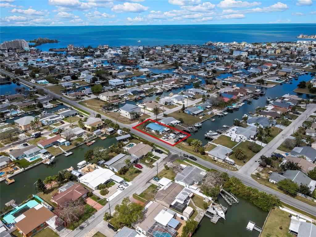 6601 Sea Ranch Drive Hudson, FL 34667 - Photo 41 of 43 an aerial view of a city with lots of residential buildings and ocean view in back
