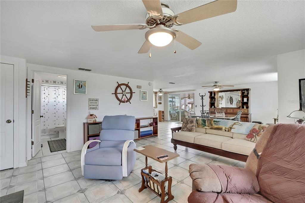 6601 Sea Ranch Drive Hudson, FL 34667 - Photo 6 of 43 a living room with furniture and a chandelier
