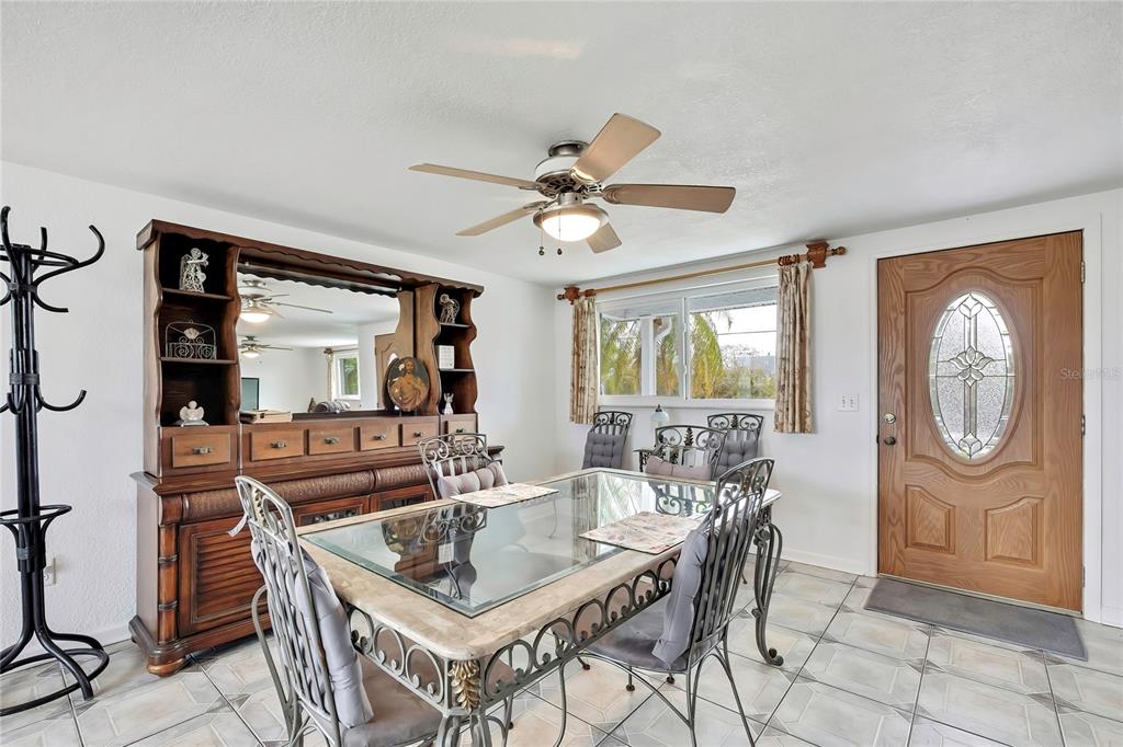 6601 Sea Ranch Drive Hudson, FL 34667 - Photo 7 of 43 a living room with furniture a large window and a chandelier