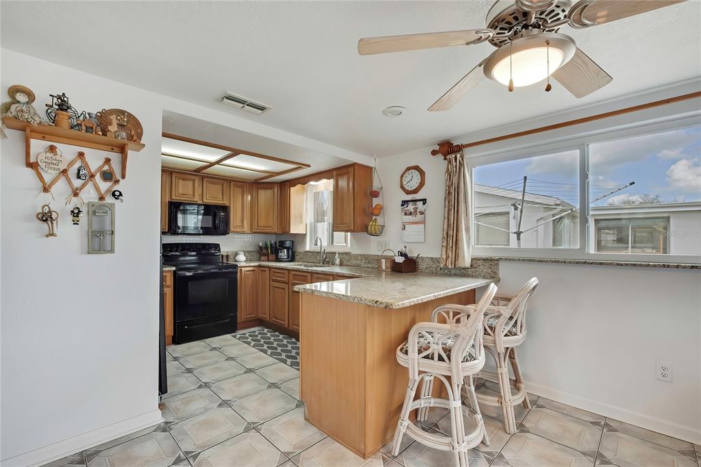 6601 Sea Ranch Drive Hudson, FL 34667 - Photo 9 of 43 a kitchen with stainless steel appliances granite countertop a sink a stove and a refrigerator