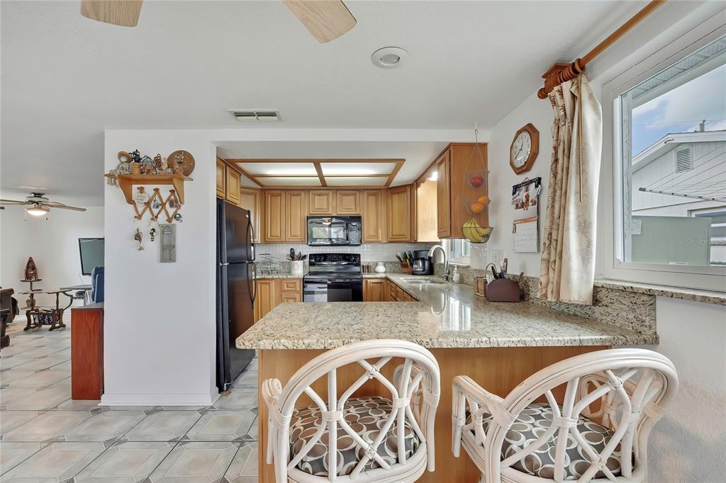 6601 Sea Ranch Drive Hudson, FL 34667 - Photo 10 of 43 a view of a kitchen with kitchen island granite countertop lots of counter top space