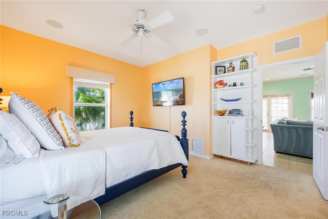 2761 Geary Street Matlacha, FL 33993 - Photo 22 of 50 a bedroom with a bed and a chandelier