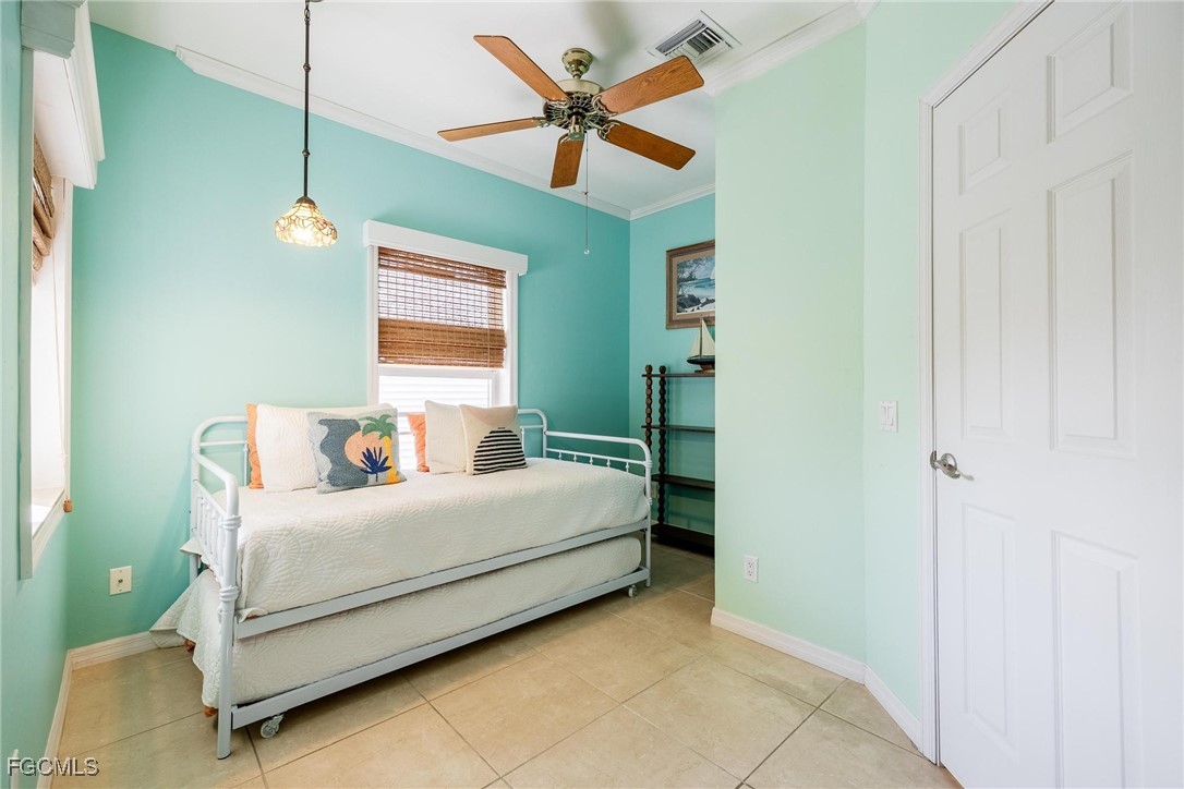 2761 Geary Street Matlacha, FL 33993 - Photo 25 of 50 a bedroom with a bed and a chandelier