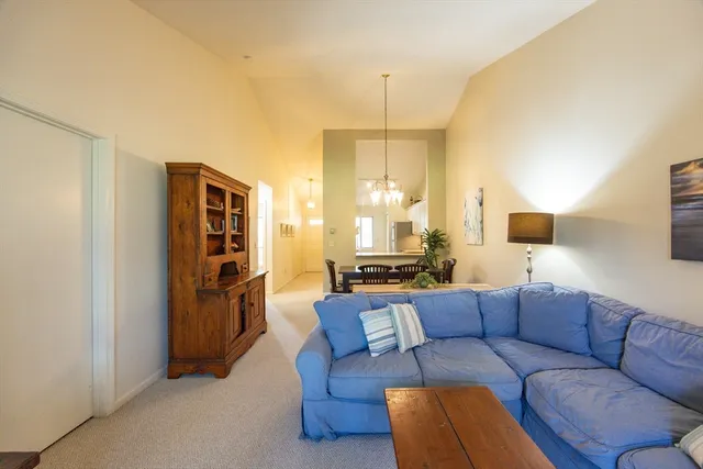 a living room with furniture a lamp and a closet