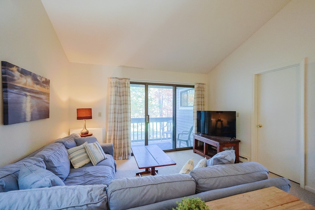 78 Eaton Lane, Unit 78 Brewster, MA 02631 - Photo 16 of 41 a living room with furniture and a flat screen tv
