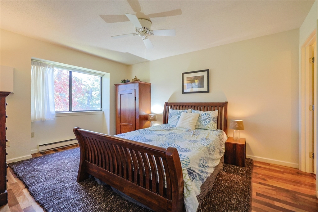 78 Eaton Lane, Unit 78 Brewster, MA 02631 - Photo 17 of 41 a bedroom with a bed and wooden floor