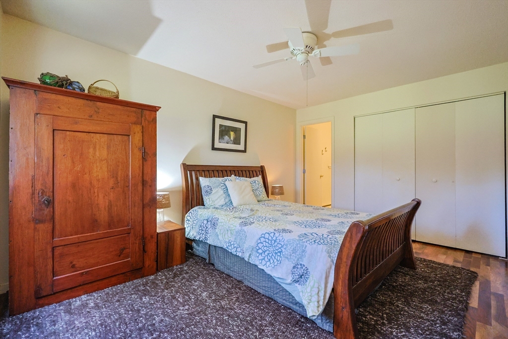 78 Eaton Lane, Unit 78 Brewster, MA 02631 - Photo 18 of 41 a bedroom with a bed and a table