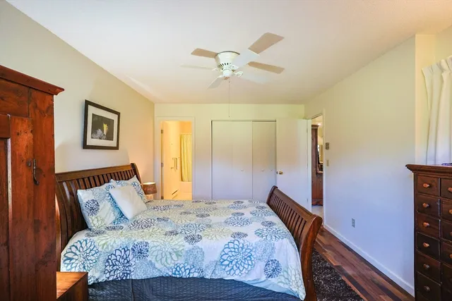 a bed sitting in a bedroom and a chandelier